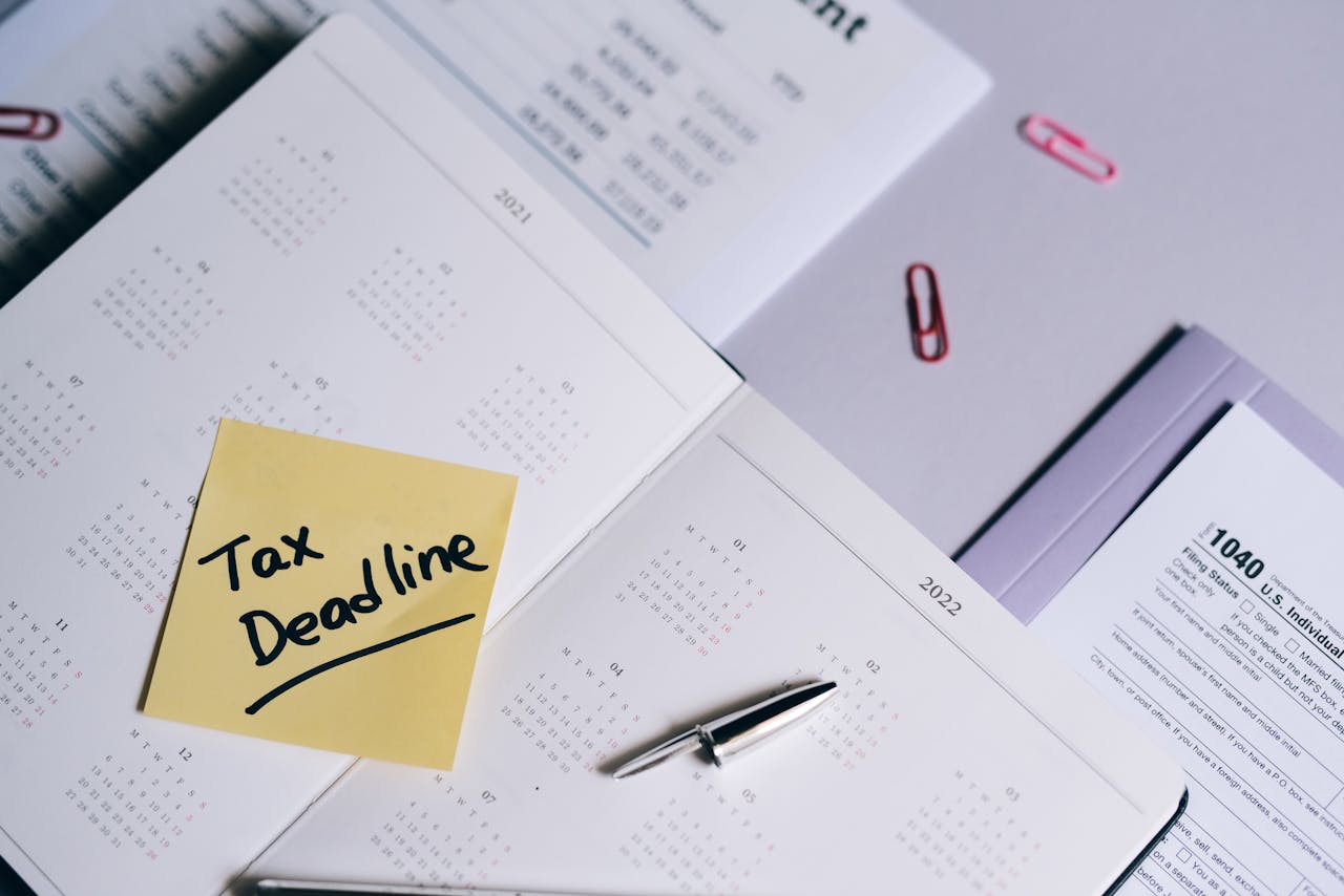 our-services-2 A calendar with a tax deadline note and tax forms, emphasizing organization.